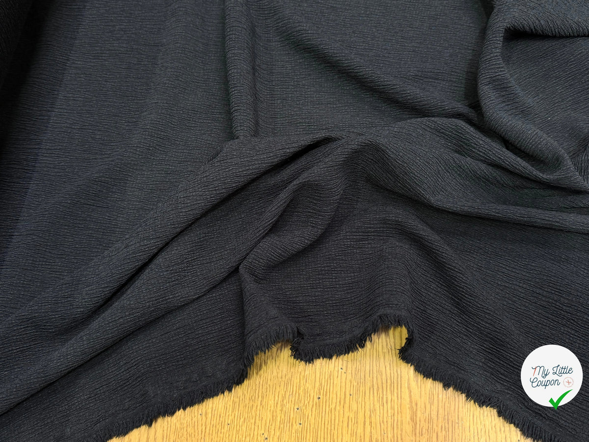 Tissu crêpe gaufré noir légèrement stretch au tombé plombant, effet double gaze