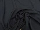 Tissu crêpe gaufré noir légèrement stretch au tombé plombant, effet double gaze