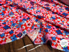 VISCOSE TOUCHÉ PEAU DE PÊCHE IMPRIMÉ FLEURS FOND ROUGE - My Little Coupon